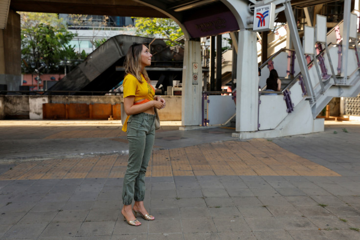 Lillian Smith, 30, from Mississippi, waits for a tour guide outside a BTS station in Bangkok