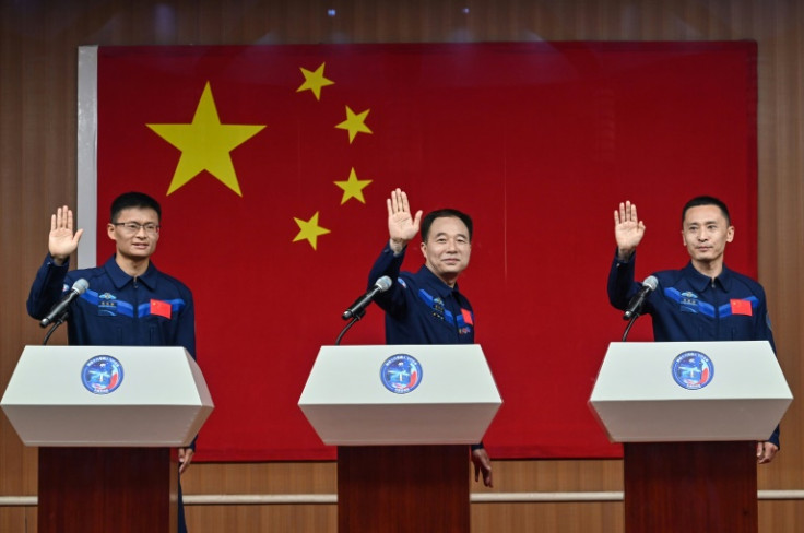Gui Haichao (L) will become the first Chinese civilian in space when he launches with mission commander Jing Haipeng (C) and space flight engineer Zhu Yangzhu