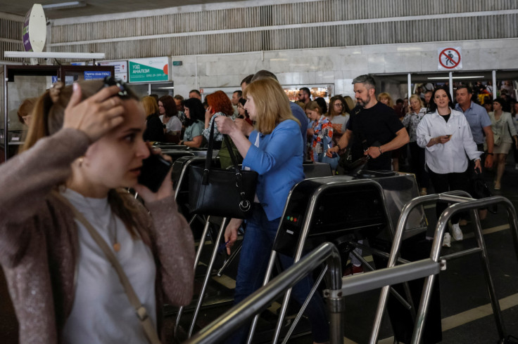 People enter a subway station to hide during an air raid alert in Kyiv