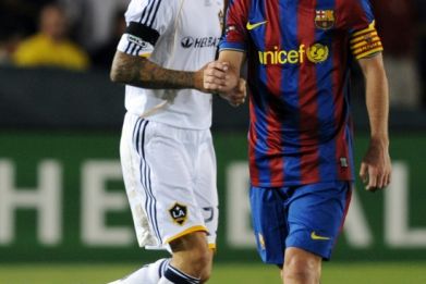 Lionel Messi in action for Barcelona against David Beckham of LA Galaxy in a friendly match in 2009