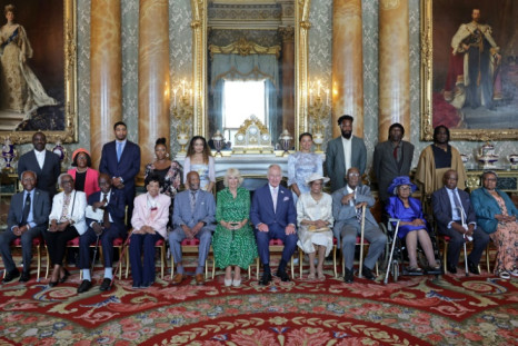 King Charles III and Queen Camilla pose with members of the Windrush generation and their relatives at a reception
