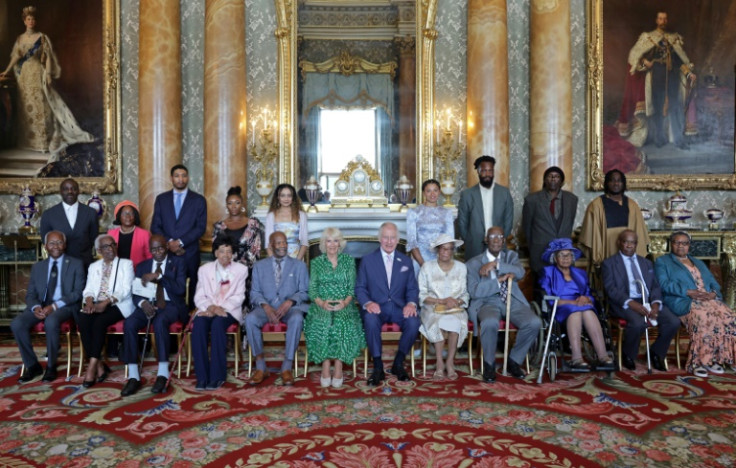 King Charles III and Queen Camilla pose with members of the Windrush generation and their relatives at a reception