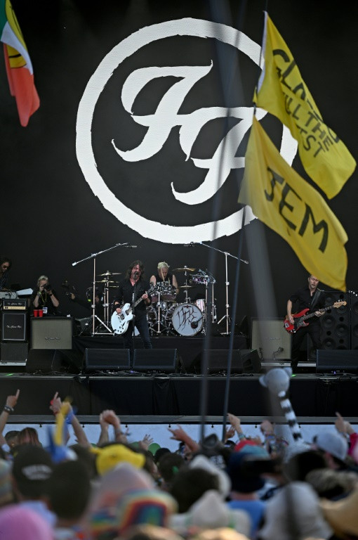 Foo Fighters' Dave Grohl (L), Josh Freese (C), and Nate Mendel, performing as The Churnups, on day three of the Glastonbury festival
