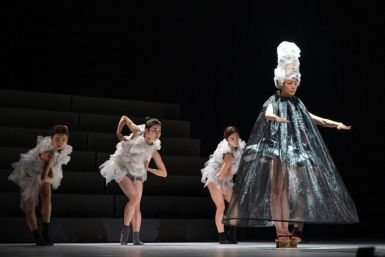 Dancers dressed in recycled plastic costumes