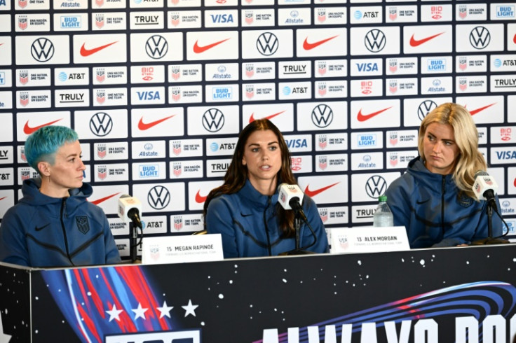 Alex Morgan (C) speaks as teammates Megan Rapinoe (L) and Lindsey Horan (R) listen during a press conference for the US 2023 Women's World Cup team