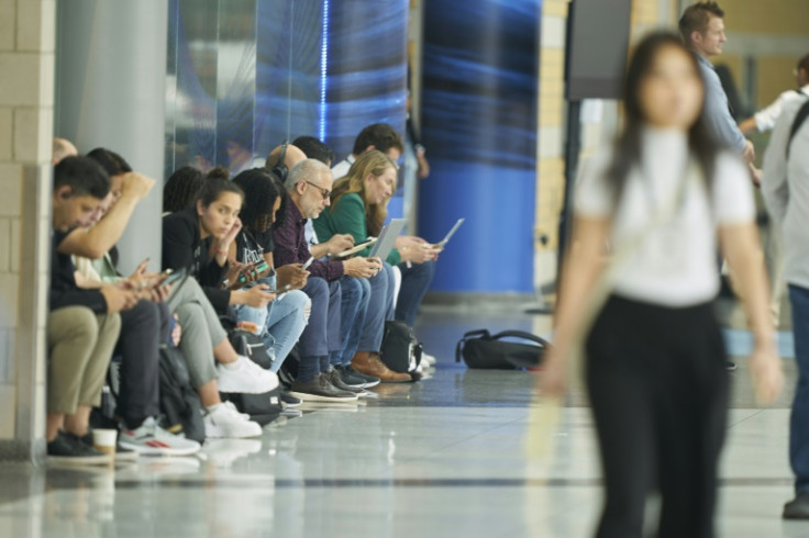 Attendees take a break  to check their devices during the Collision conference in Toronto