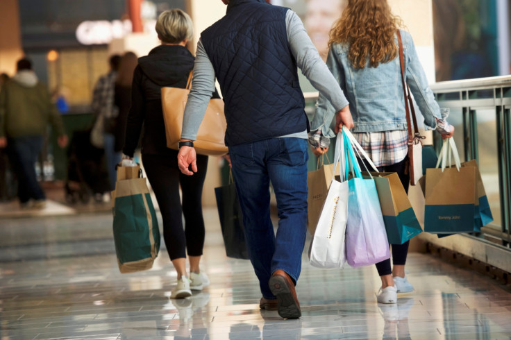 Shoppers carry bags of purchased merchandise