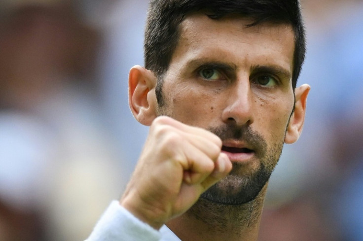 Novak Djokovic celebrates after beating Pedro Cachin in the first round at Wimbledon