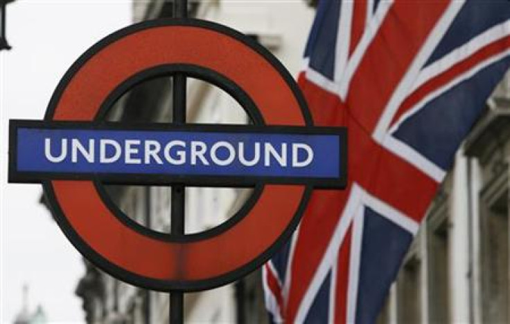 A Union Flag flies near an underground sign for Westminster tube station in London