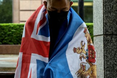 A Hong Konger living in Taiwan wears the British colonial flag of Hong Kong