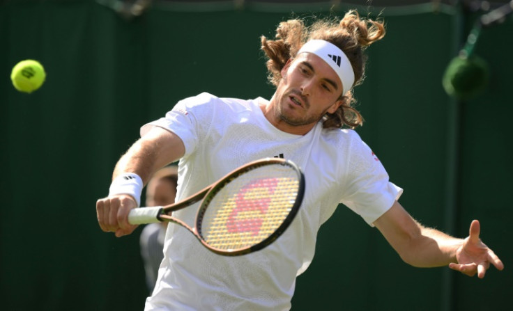 Stefanos Tsitsipas in action against Dominic Thiem in the Wimbledon first round