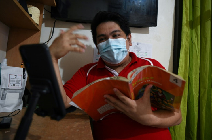The coronavirus pandemic had a devastating impact on global access to education, with many unable to attend school due to lack of access to mobile devices used for remote learning, as Filipino teacher Kristhean Navales uses here in 2021
