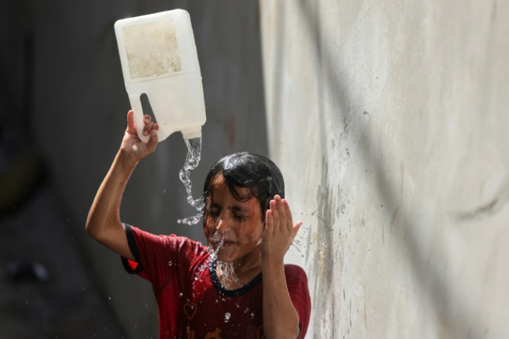 Many around the world tried to stay cool by splashing water on themselves, like this boy in Gaza City