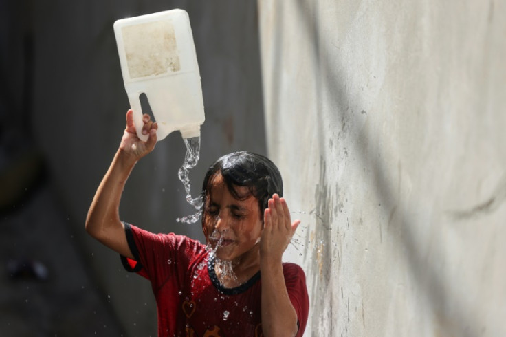 Many around the world tried to stay cool by splashing water on themselves, like this boy in Gaza City