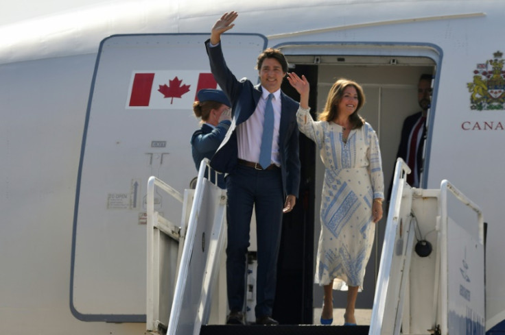 Canadian Prime Minister Justin Trudeau and his wife Sophie Gregoire greet as they arrive at an airport in Santa Lucia, Mexico, on January 9, 2023