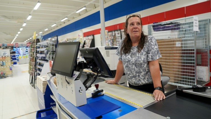 Supermarket manager standing at the counter