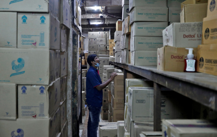 A worker inspects boxes in a store
