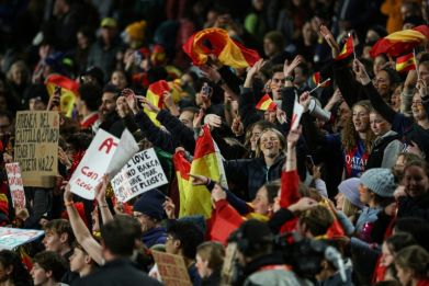 Spain supporters, part of a record crowd at Eden Park in Auckland, celebrate their team reaching the World Cup final