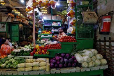 Vendor selling vegetables in a retail market