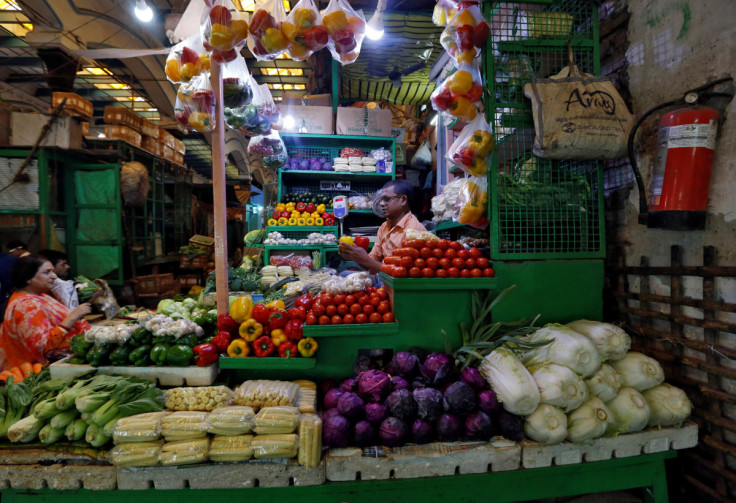 Vendor selling vegetables in a retail market