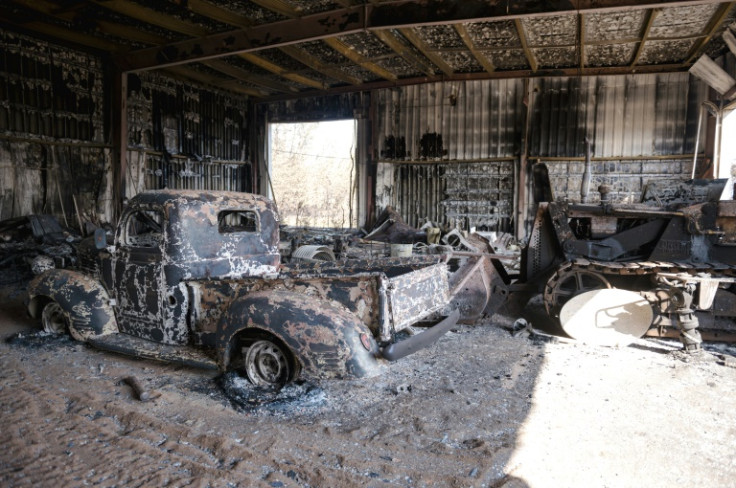 Charred remains are seen on the side of the road on the highway in Enterprise. The tiny hamlet, a key junction on the road south from Yellowknife in the Northwest Territories, has been almost completely destroyed by fires