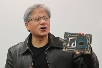 Nvidia CEO Jensen Huang with one of the firm's processors -- prized for building AI applications
