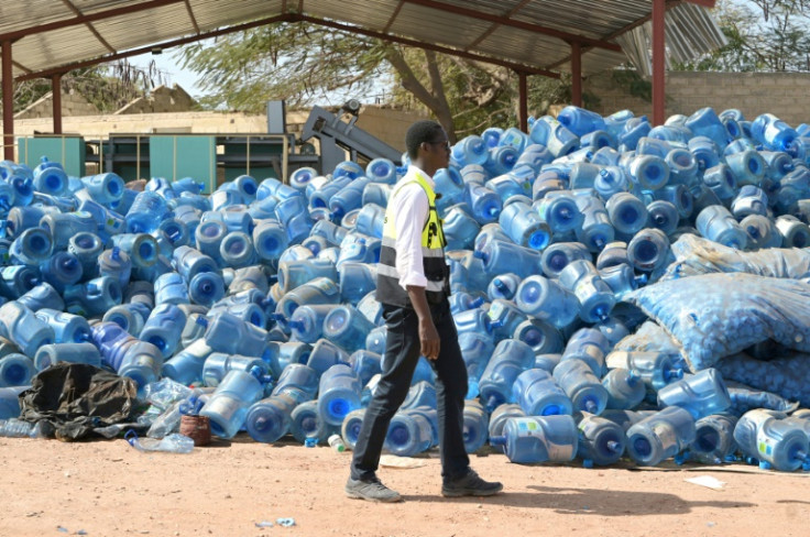 Waste collector with water cannisters awaiting recycling