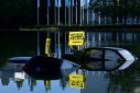 Greenpeace activists submerged three cars in a small lake outside the IAA convention centre