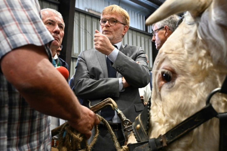Agriculture Minister Marc Fesneau (C) with a bull at the International Livestock Trade Fair near Rennes