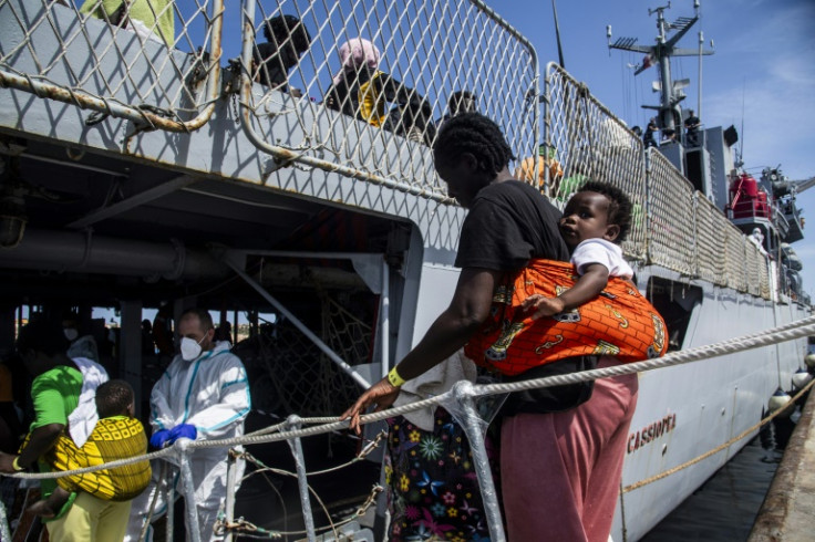 Migrants arrive in the harbor of the Italian island of Lampedusa before being transferred to Porto Empedocle in Sicily on September 15, 2023