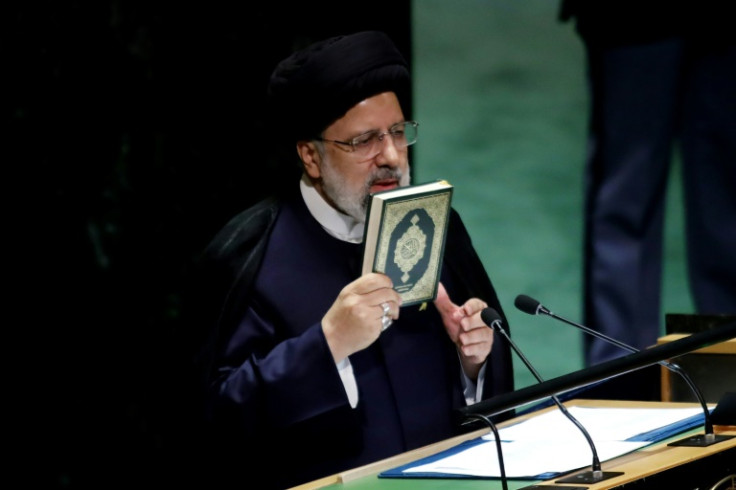 Iranian President Ebrahim Raisi holds the Koran as he addresses the United Nations General Assembly