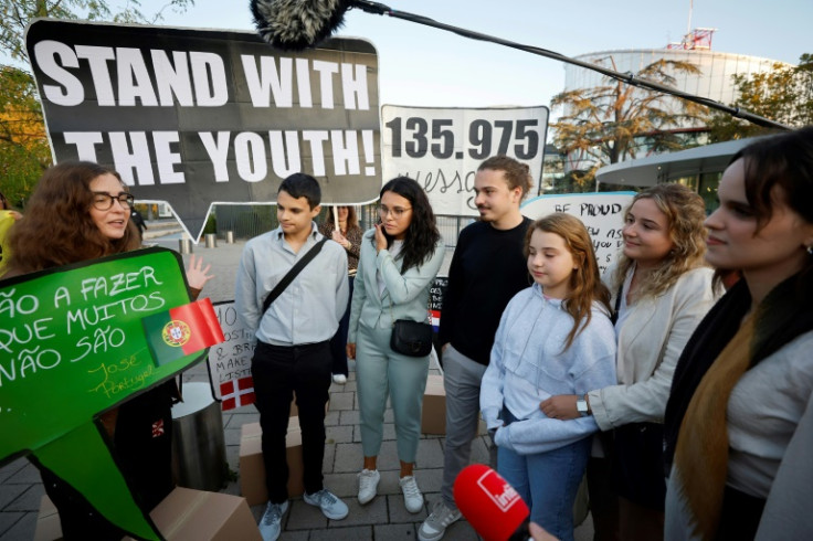 The Portuguese plaintiffs held placards as they arrived at the ECHR on Wednesday