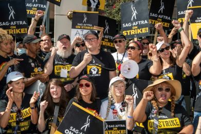 Some of the SAG-AFTRA negotiating committee address members at the picket line outside Warner Brothers offices in Burbank, California