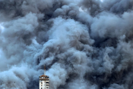 Smoke billows above Gaza City after an Israeli air strike hit the Palestine Tower building on October 7, 2023