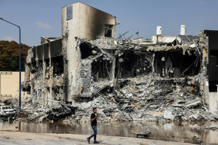 A man walks past an Israeli police station in Sderot after it was damaged during battles to dislodge Hamas militants