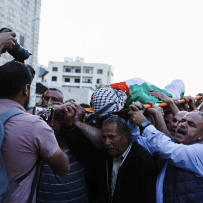 Mourners carry a body in the west bank palestine.  