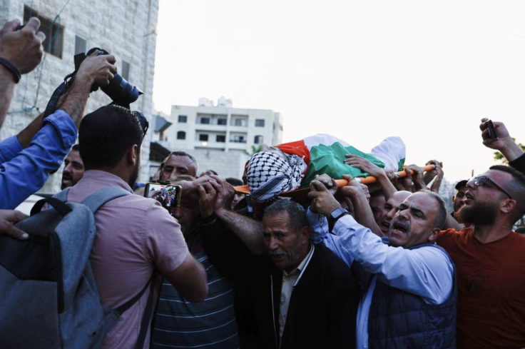 Mourners carry a body in the west bank palestine.  