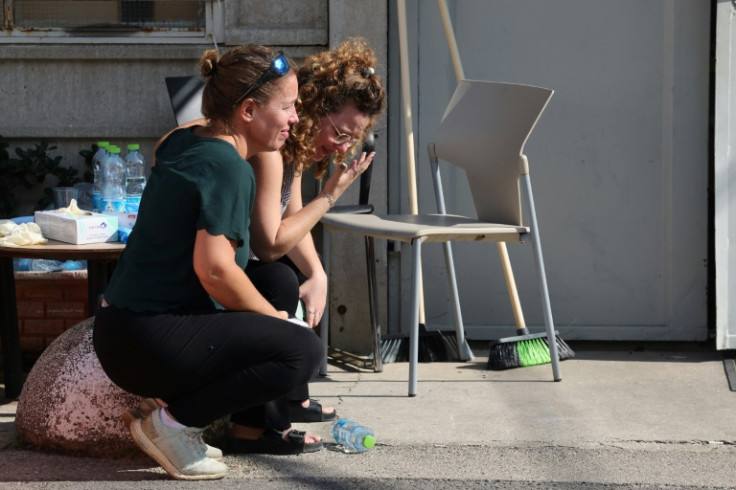 Relatives wait for the body of a loved one to be identified