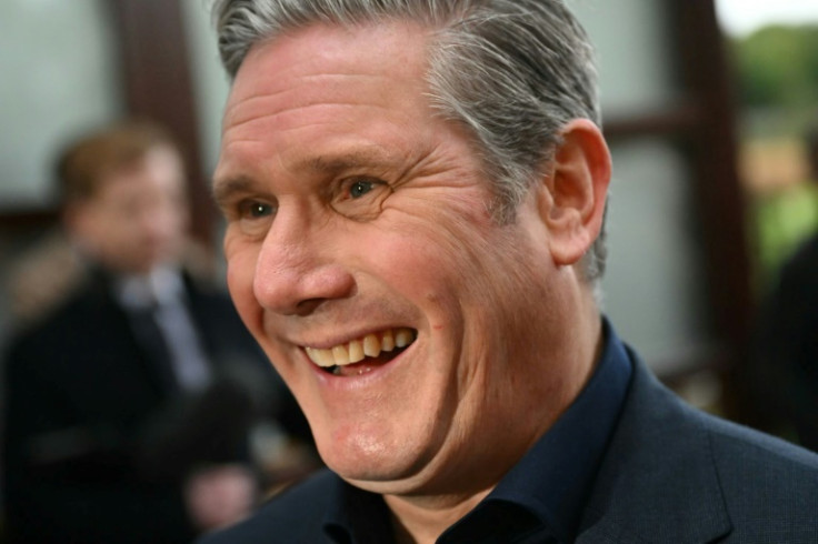 Britain's main opposition Labour leader Keir Starmer smiles as he meets supporters after his party won the Mid-Bedfordshire by-election on October 20, 2023