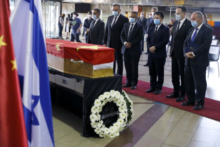 Chinese officials pay respects in front of the coffin of Chinese ambassador to Israel Du Wei, who died at his home, during a ceremony at Ben-Gurion International Airport in 2020
