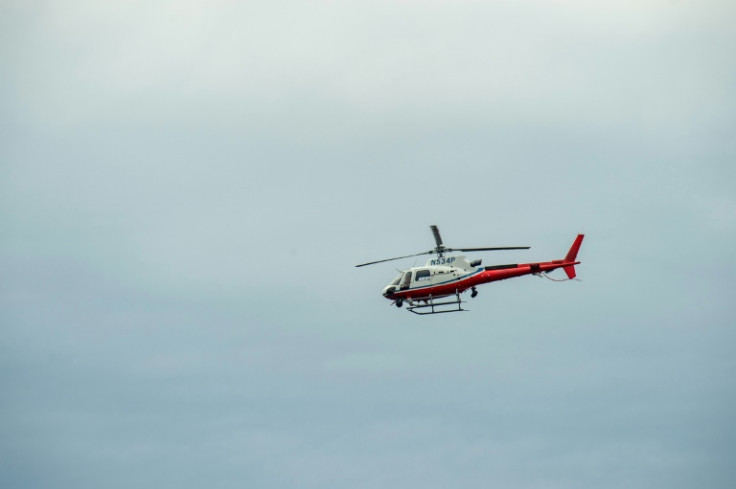 A helicopter flies overhead in Lewiston, Maine on October 26, 2023