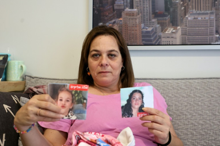 Maayan Zin shows pictures of her daughters Ela, 8, and Dafna, 15, who are believed to be among the hostages Hamas militants took during the October 7 attack