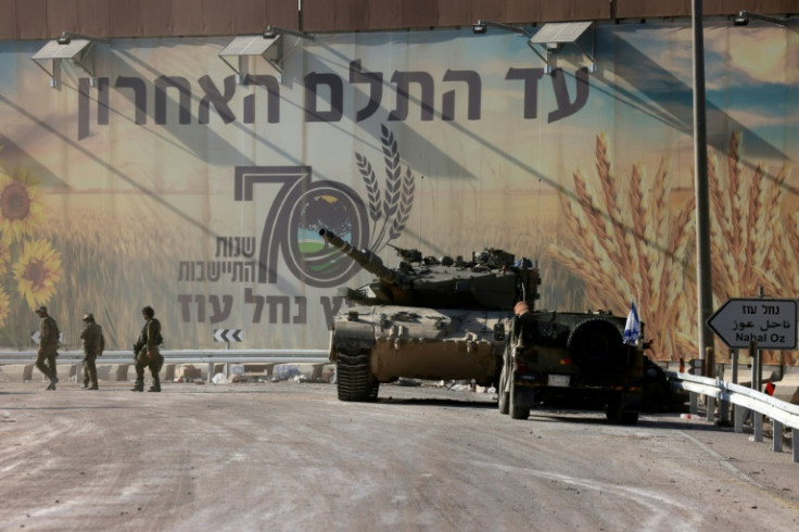 Israeli troops patrol near kibbutz Nahal Oz on the border with the Gaza Strip on October 15, 2023