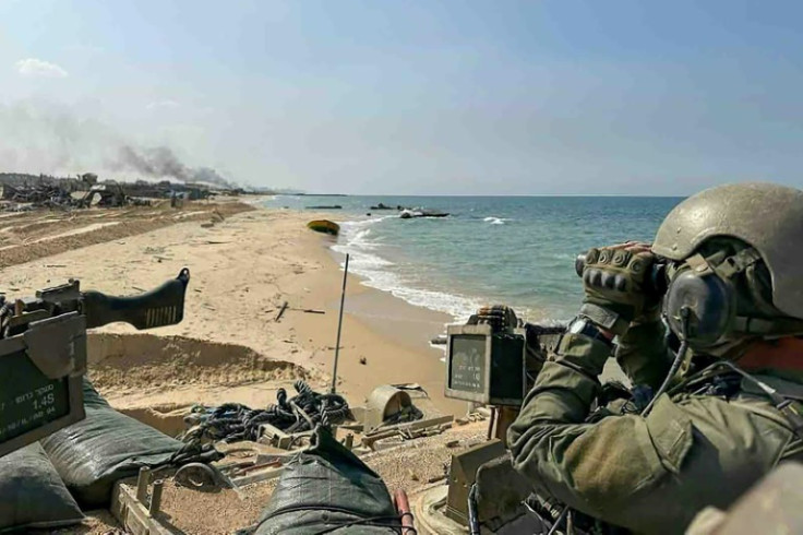 This picture released by the Israeli army on November 5, 2023 shows Israel troops patrolling along the shore in the Gaza Strip as battles between Israel and the Palestinian Hamas movement continue