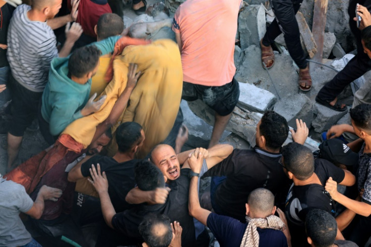 A man reacts as the body of his brother is removed from under the rubble of a building destroyed by an Israeli strike on the Al-Maghazi refugee camp in Deir Balah in the central Gaza Strip, on November 5, 2023