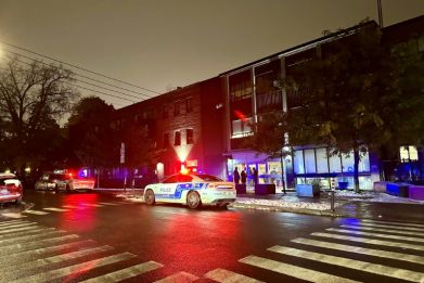 Police cars sit in front of Talmud Torah Elementary School as parents pick up their children in the Cote-des-Neiges neighborhood of Montreal after it and another area Jewish school were hit by gunfire, amid tensions in Canada over the Israel-Hamas war