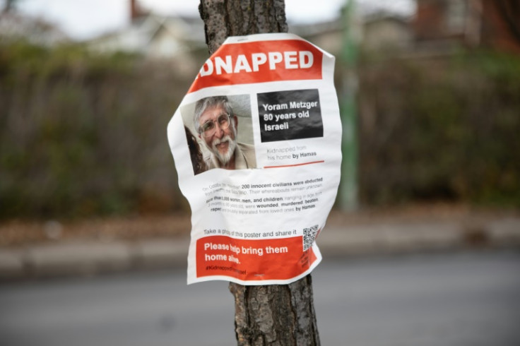 A poster showing the photo of 80 year old Israeli hostage Yoram Metzger is displayed on a tree in Hampstead, Quebec, Canada