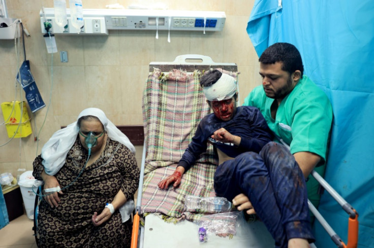 A nurse moves an an injured Palestinian boy in the the Al-Aqsa Hospital