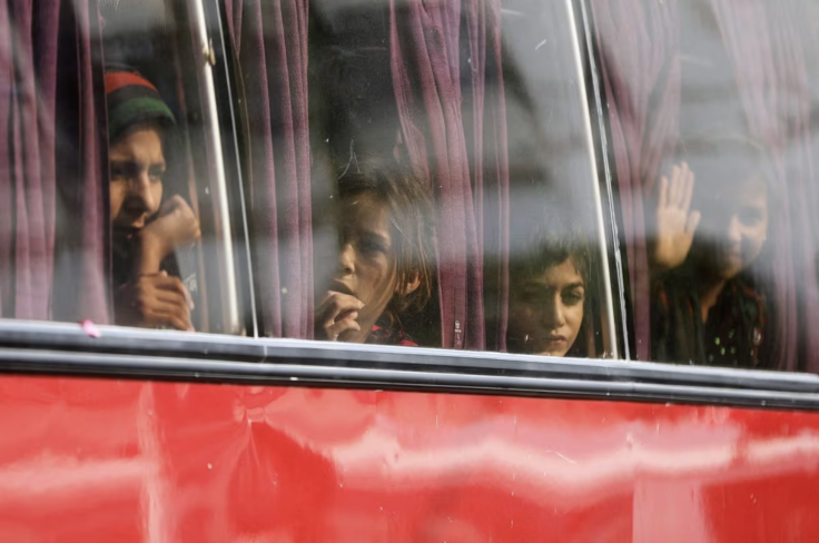 Afghan children wave as they are deported