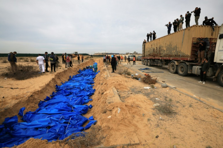 Palestinians bury bodies in a mass grave in Khan Yunis cemetery, in the southern Gaza Strip